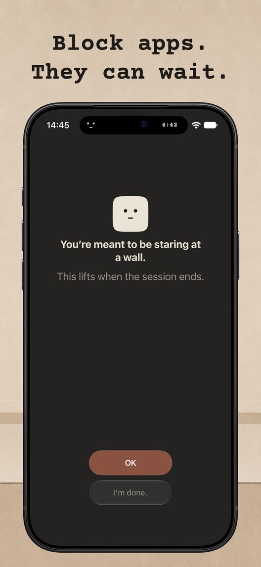 Block apps. They can wait. An iPhone showing a blocked app screen with the face and the line: you&rsquo;re meant to be staring at a wall. This lifts when the session ends.